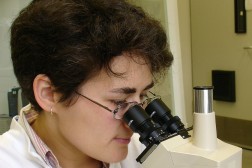 Scientist looking into a microscope