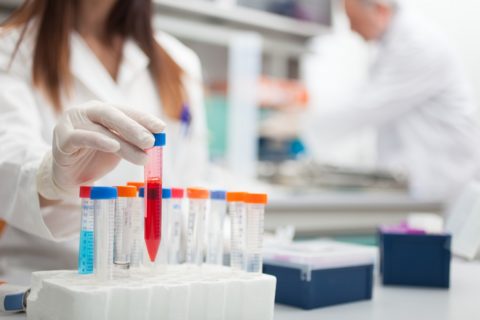 Man and woman in lab with test tubes