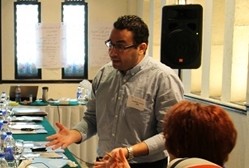 A man leading a training session in a room