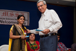 Laxmi receives a cash prize for her achievements