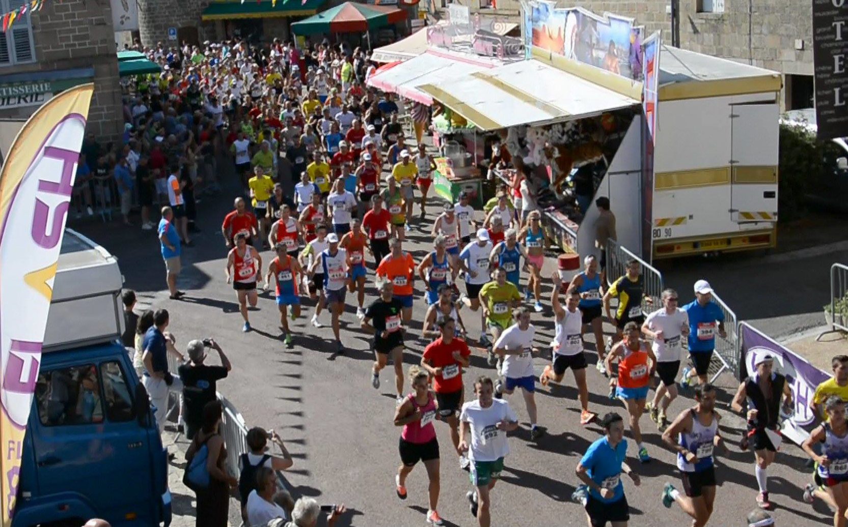 a sunny day in a french villaege, the road is full of runners