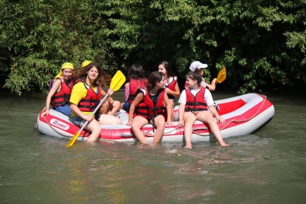 young people sitting on an inflatable raft