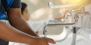 image of someone washing their hands, to represent precautions against COVID-19