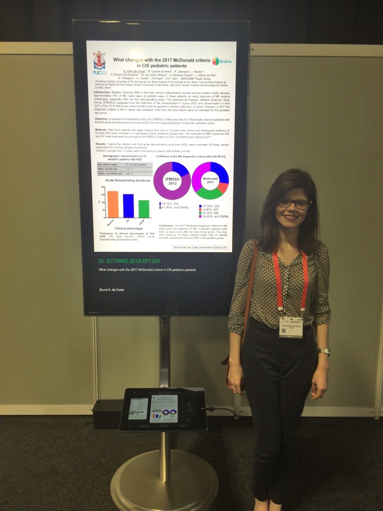 Image of a woman standing in front of a digital poster at a conference